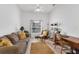 Inviting living room featuring a comfortable couch, warm lighting, and a dedicated workspace with stylish decor at 5240 Hyland Hills Ave # 1426, Sarasota, FL 34241
