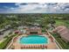 Aerial view of the community pool with lounge seating, a covered area, and nearby parking at 5240 Hyland Hills Ave # 1426, Sarasota, FL 34241