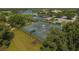 Aerial view of multiple tennis courts surrounded by lush landscaping and trees at 5240 Hyland Hills Ave # 1426, Sarasota, FL 34241