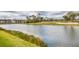 Scenic water view with lush green landscaping and community buildings in the background at 5240 Hyland Hills Ave # 1426, Sarasota, FL 34241