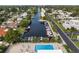 Stunning aerial view of the community with waterfront access, boat docks, and a sparkling swimming pool at 5512 Riverbluff Cir # V-16, Sarasota, FL 34231