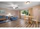 Welcoming living room featuring a comfortable seating area and a round table by the bright window at 5512 Riverbluff Cir # V-16, Sarasota, FL 34231