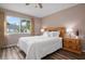 Comfortable main bedroom featuring wood floors, neutral decor, and a bright window for natural light at 5512 Riverbluff Cir # V-16, Sarasota, FL 34231