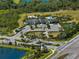 Aerial view of community amenities with lake, community pool, clubhouse, and walking trail at 5744 Woodland Sage Dr, Sarasota, FL 34238