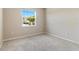 Neutral bedroom has a carpeted floor, window, and base trim at 5744 Woodland Sage Dr, Sarasota, FL 34238