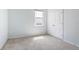 Bedroom with neutral carpet, white trim, and a window for natural light at 5744 Woodland Sage Dr, Sarasota, FL 34238