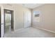 A neutrally decorated bedroom with carpet, white trim and doors, and view into hallway at 5744 Woodland Sage Dr, Sarasota, FL 34238
