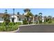 Elegant clubhouse featuring stone accents, lush landscaping, and inviting entrance at 5744 Woodland Sage Dr, Sarasota, FL 34238