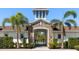 Welcoming community entrance with stone accents, lush landscaping, and gated access at 5744 Woodland Sage Dr, Sarasota, FL 34238