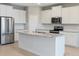 Well-equipped kitchen with stainless steel appliances, white cabinets, and granite countertops at 5744 Woodland Sage Dr, Sarasota, FL 34238
