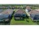 Aerial view showcasing a backyard with a screened-in patio, lush green lawn and golf course views at 5817 Brandon Run, Bradenton, FL 34211