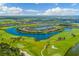 Stunning aerial view of a community built around a lake and golf course at 5817 Brandon Run, Bradenton, FL 34211