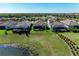 Aerial view of screened-in back porches overlooking a pond with lush landscaping at 5817 Brandon Run, Bradenton, FL 34211