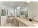 Luxurious bathroom with dual sinks, soaking tub, and walk-in shower at 5817 Brandon Run, Bradenton, FL 34211
