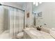 Well-lit bathroom featuring a shower and a granite countertop vanity, plus stylish fixtures and decor at 5817 Brandon Run, Bradenton, FL 34211