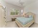 Cozy bedroom with shuttered windows, light colored wooden furniture, and pleasant natural light at 5817 Brandon Run, Bradenton, FL 34211