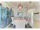 Well-lit dining area featuring a classic chandelier, neutral decor, and seating for six at 5817 Brandon Run, Bradenton, FL 34211