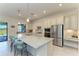Gourmet kitchen with a large island, stainless steel appliances, and a breakfast bar at 5817 Brandon Run, Bradenton, FL 34211