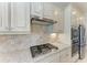 Gourmet kitchen featuring stainless steel gas cooktop and custom cabinetry at 5817 Brandon Run, Bradenton, FL 34211