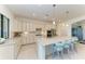 Bright kitchen featuring a large island with seating, modern appliances, and plenty of counter space at 5817 Brandon Run, Bradenton, FL 34211