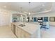 Open-concept kitchen with large island, granite countertops, and stainless steel appliances at 5817 Brandon Run, Bradenton, FL 34211