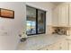 Stylish kitchen countertop with views of the outdoor patio and a serene landscape at 5817 Brandon Run, Bradenton, FL 34211