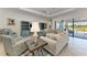 Inviting living room with ample seating, tasteful decor, and sliding glass doors to the outside at 5817 Brandon Run, Bradenton, FL 34211