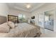 Bright main bedroom with a ceiling fan and access to the outdoor living space at 5817 Brandon Run, Bradenton, FL 34211