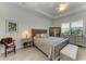 Cozy main bedroom with tray ceilings, dresser, and sitting area at 5817 Brandon Run, Bradenton, FL 34211
