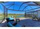 Screened lanai with comfortable seating overlooking a serene pond view, ideal for outdoor relaxation at 5817 Brandon Run, Bradenton, FL 34211