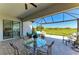 Screened-in patio featuring brick flooring, comfortable seating, and a serene view of the lush green landscape at 5817 Brandon Run, Bradenton, FL 34211
