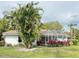 White home featuring a large palm tree and verdant bushes in the spacious backyard at 5906 Garden Lakes Majestic, Bradenton, FL 34203