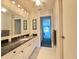 Full bathroom features granite counters, large mirror, and plenty of light at 5906 Garden Lakes Majestic, Bradenton, FL 34203
