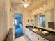 Full bathroom features granite counters, large mirror, and walk-in shower at 5906 Garden Lakes Majestic, Bradenton, FL 34203