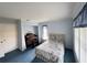Comfortable bedroom with blue carpet, white walls, and a view outside at 5906 Garden Lakes Majestic, Bradenton, FL 34203
