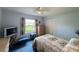 Comfortable bedroom with blue carpet, light walls, and plenty of light at 5906 Garden Lakes Majestic, Bradenton, FL 34203