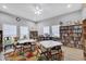 Clubhouse features tables, chairs, and bookshelves full of literature on a multi colored rug at 5906 Garden Lakes Majestic, Bradenton, FL 34203