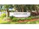 Welcome to Garden Lakes: an inviting community entrance framed by lush landscaping and stately palm trees at 5906 Garden Lakes Majestic, Bradenton, FL 34203