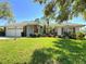 Charming single-story home with a well-manicured lawn, beautiful landscaping, and a two-car garage at 5906 Garden Lakes Majestic, Bradenton, FL 34203