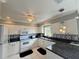 Bright kitchen features granite counters, white cabinets, and sleek, modern appliances at 5906 Garden Lakes Majestic, Bradenton, FL 34203