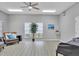 Bright living room featuring hard wood floors, natural lighting, and calming gray walls at 5906 Garden Lakes Majestic, Bradenton, FL 34203