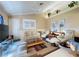 Comfortable living room with neutral decor, vaulted ceiling, ceiling fan, and ample seating at 5906 Garden Lakes Majestic, Bradenton, FL 34203