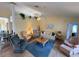 Cozy living room with vaulted ceilings, ceiling fan, comfortable seating, and lots of natural light at 5906 Garden Lakes Majestic, Bradenton, FL 34203