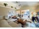 Spacious living room with vaulted ceilings, tile flooring, comfortable seating, and neutral paint at 5906 Garden Lakes Majestic, Bradenton, FL 34203