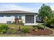 Beautifully landscaped backyard with a screened lanai and a variety of colorful plants and mulch beds at 5998 Amberly Dr, Bradenton, FL 34208