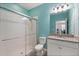 The bathroom has a granite countertop vanity with a glass-enclosed tile shower at 5998 Amberly Dr, Bradenton, FL 34208
