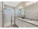 The bathroom features double sinks, granite countertops, and a tiled glass-enclosed shower at 5998 Amberly Dr, Bradenton, FL 34208