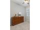 This cozy bedroom features a wood dresser, a ceiling fan, and a window for natural light at 5998 Amberly Dr, Bradenton, FL 34208