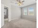 This neutral bedroom features carpet, two windows for natural light, and a ceiling fan at 5998 Amberly Dr, Bradenton, FL 34208