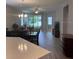 Open concept dining room showcases chandelier lighting, and sliding doors to the outside at 5998 Amberly Dr, Bradenton, FL 34208
